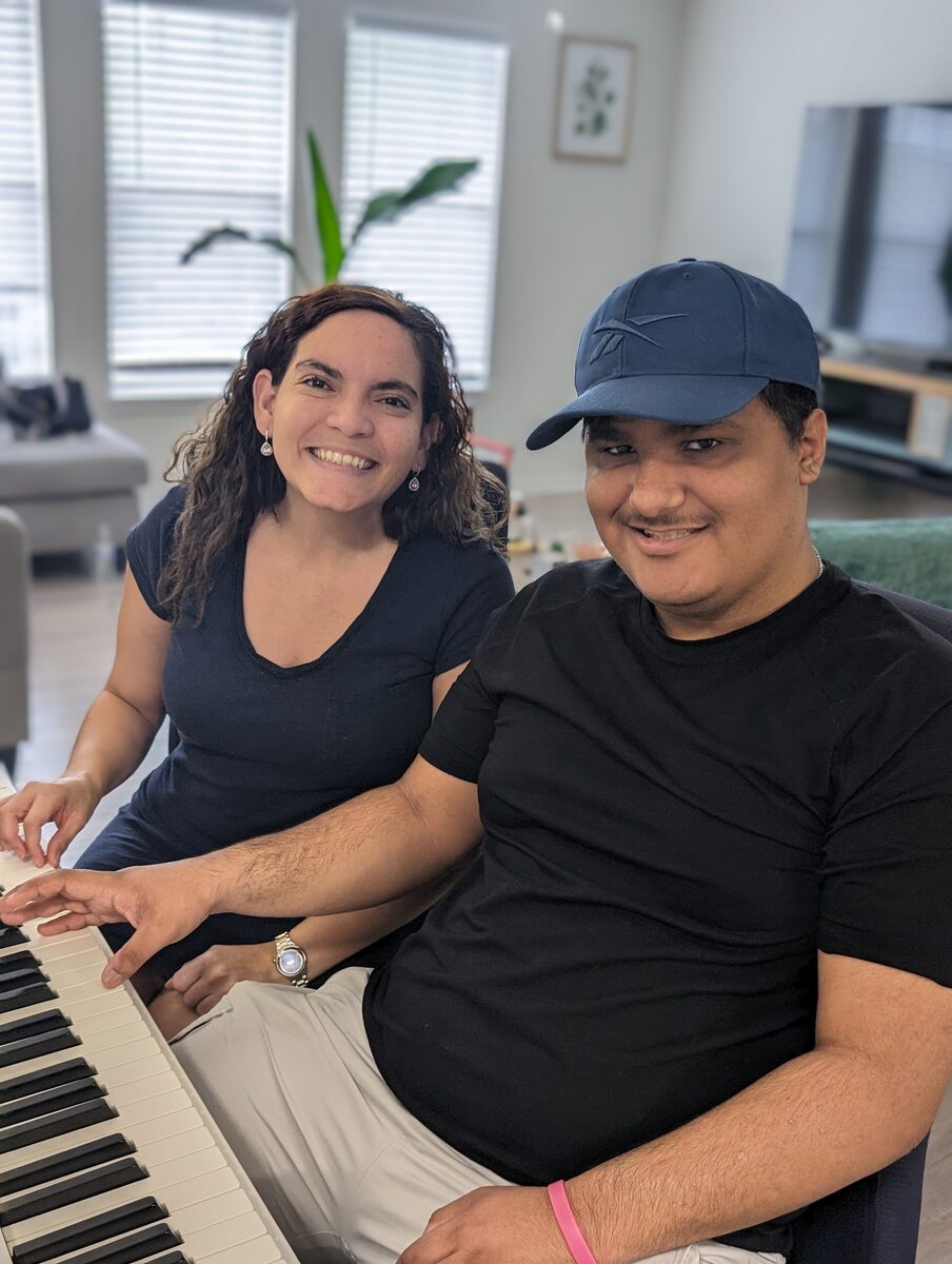 Raiza teaching Alejandro at the piano